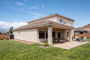 Rear view of house featuring a mountain view, a patio area, and stucco siding