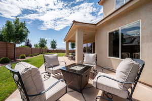Fenced backyard featuring an outdoor living space with a fire pit and a patio area