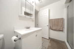 Bathroom featuring vanity and tile patterned flooring