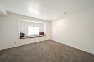 Unfurnished room with carpet and baseboards