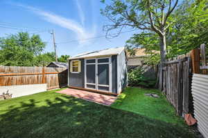 View of shed with a fenced backyard