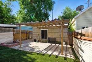 Fenced backyard featuring a patio area and a pergola