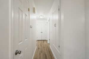 Hall featuring light wood finished floors and ornamental molding