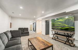 Living area with light colored carpet, recessed lighting, and ornamental molding