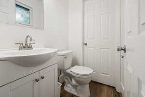 Bathroom featuring vanity and wood finished floors