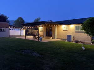 Back of property with a patio area and brick siding