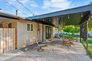 View of patio with a ceiling fan and outdoor dining area