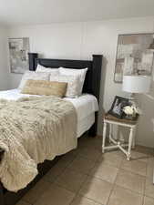 Bedroom with light tile patterned flooring