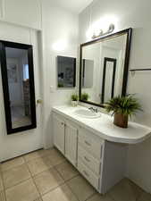 Bathroom with tile patterned floors and vanity