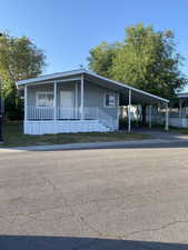Manufactured / mobile home with a carport and covered porch