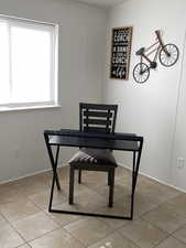 Dining area featuring light tile patterned floors and baseboards