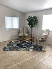 Sitting room with tile patterned flooring and a textured ceiling