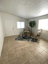 Dining space with tile patterned floors and a textured ceiling