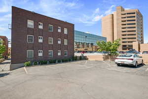 View of building exterior featuring uncovered parking