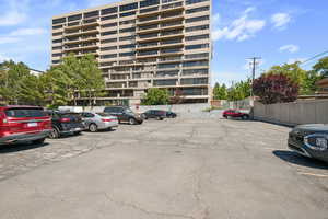 View of apartment building / complex with uncovered parking