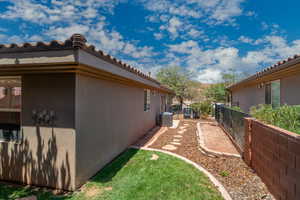 View of property exterior with stucco siding and a tile roof