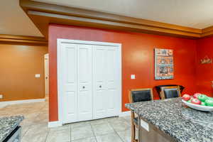 Dining space featuring light tile patterned flooring and baseboards