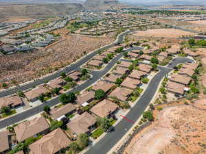 Aerial view of property and surrounding area with mountains and nearby suburban area