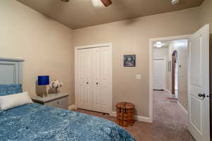 Bedroom featuring carpet floors, a closet, and ceiling fan