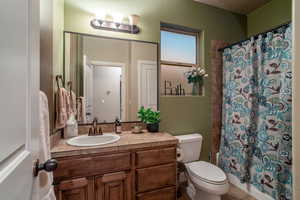 Full bath with vanity and shower / bath combination with curtain
