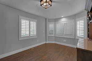 Spare room with dark wood-style flooring and recessed lighting