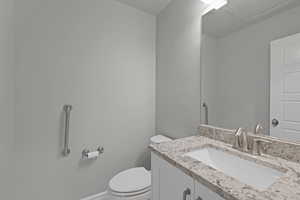 Half bath with vanity and toilet