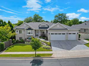 Craftsman house featuring a garage, concrete driveway, roof with shingles, stone siding, and stucco siding