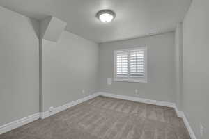 Spare room with carpet floors and a textured ceiling