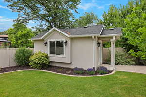 View of side of property featuring stucco siding and roof with shingles