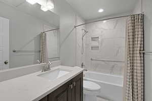 Full bathroom with vanity, shower / bath combination with curtain, and recessed lighting