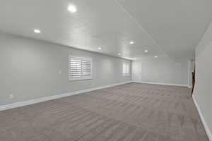 Empty room with recessed lighting and carpet floors