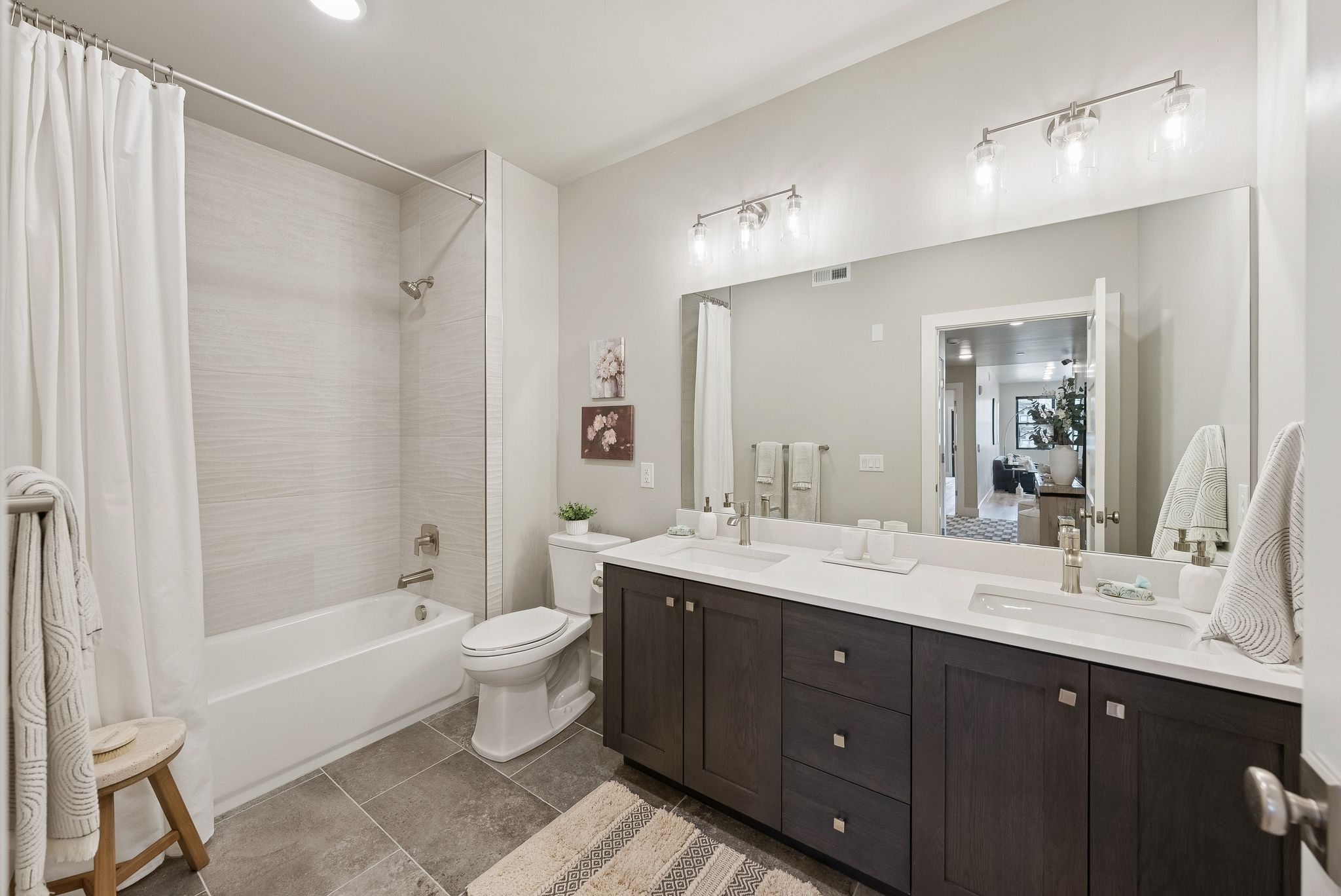 Full bathroom with shower / bath combo with shower curtain and double vanity