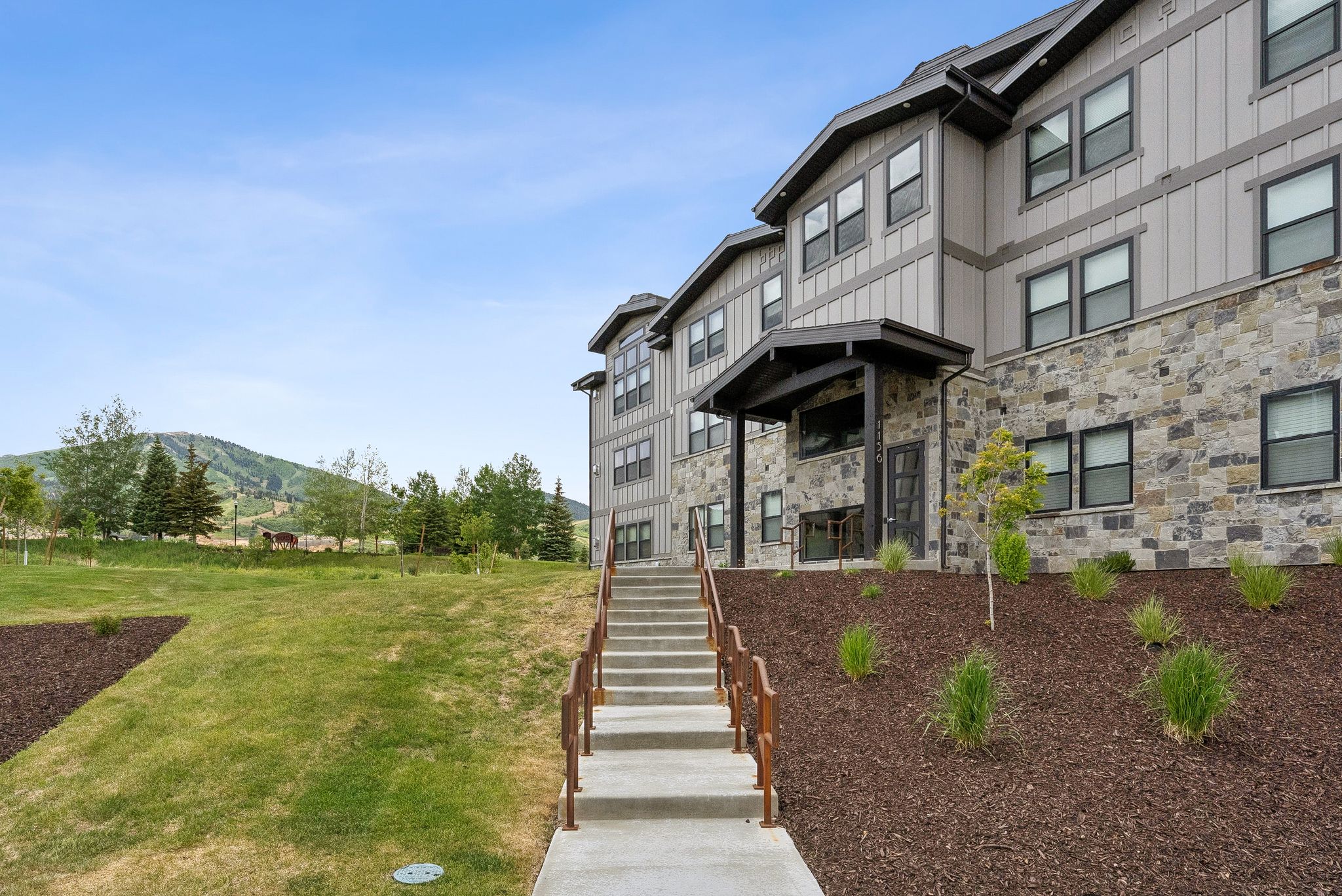 View of building exterior featuring stairs and a mountain view