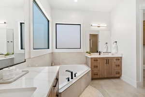 Full bath featuring vanity and a garden tub