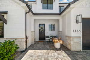 Doorway to property with stone siding
