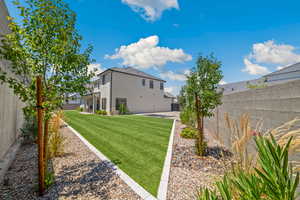 Back of property with stucco siding and a fenced backyard