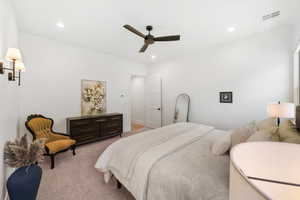 Bedroom with light colored carpet, recessed lighting, and ceiling fan
