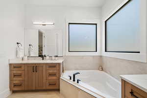 Bathroom featuring vanity and a garden tub
