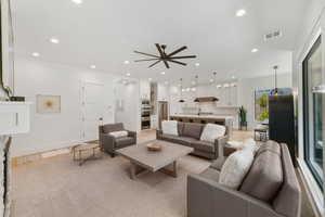 Living room with a ceiling fan and recessed lighting