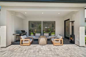View of patio / terrace featuring grilling area and an outdoor living space with a fire pit