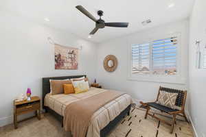 Bedroom with a ceiling fan, recessed lighting, and carpet flooring