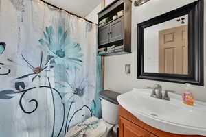 Full bath with vanity and curtained shower