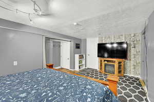 Bedroom featuring a textured ceiling and a closet