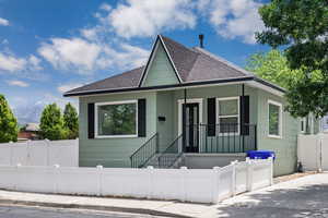 Bungalow-style house with roof with shingles and a fenced front yard