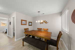Dining room featuring light wood-type flooring and baseboards