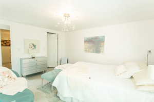 Bedroom with a closet and a chandelier