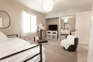Tiled bedroom with a chandelier