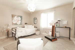 Bedroom featuring a chandelier and tile patterned flooring