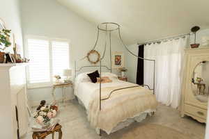 Bedroom with lofted ceiling and baseboards