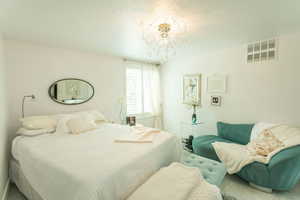 Bedroom featuring a chandelier